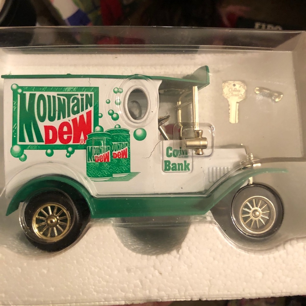 Vintage Mountain Dew Die Cast Bank With gold key.